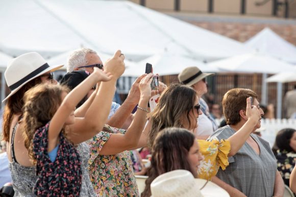 Crowd holding up cameras and phones