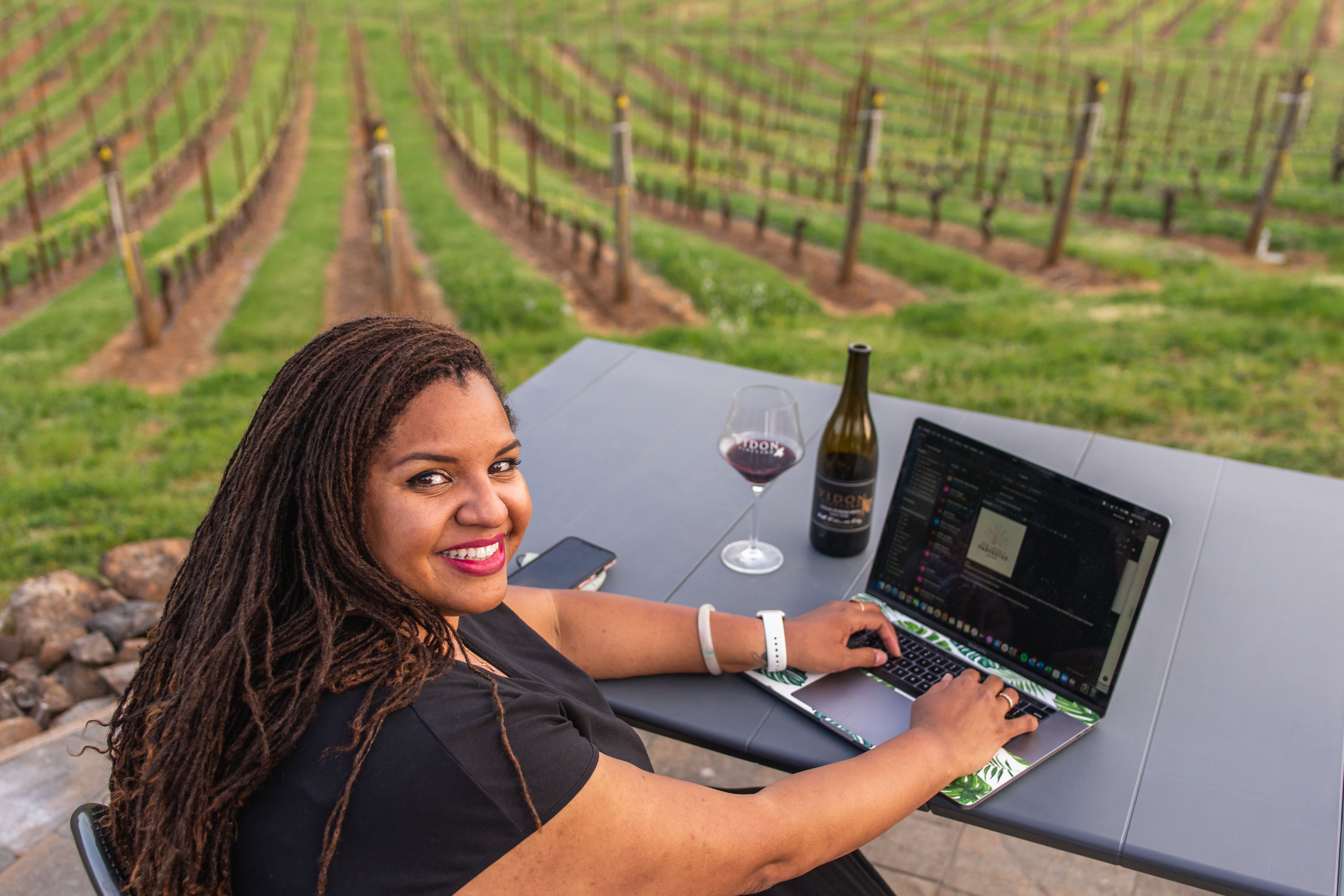 tiquette bramlett at desk overlooking vineyard