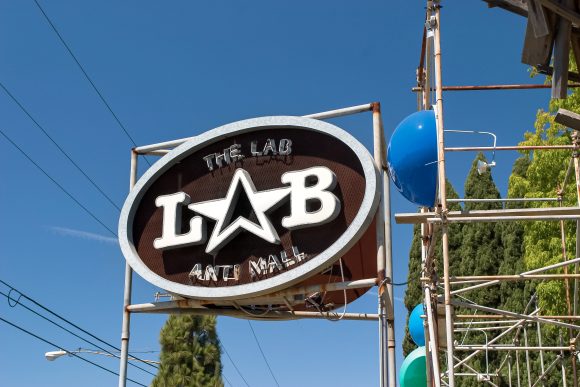 Sign for The Lab Anti-Mall atop scaffolding