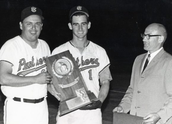 Baseball players winning trophy