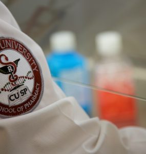 close up photo of pharmacy student's white coat with chapman logo