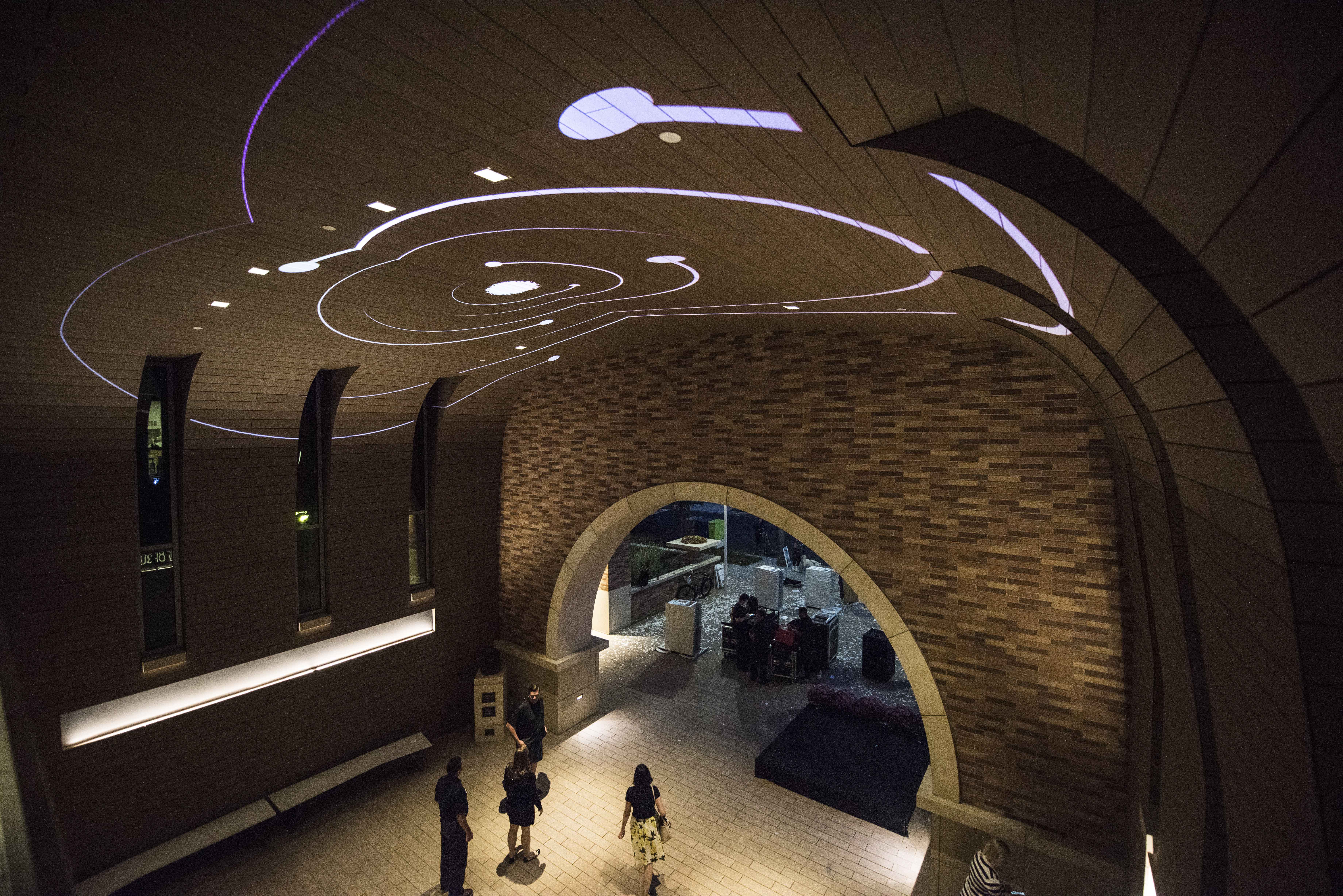 he vaulted ceiling at Keck Center comes to life at night with science-themed projections. 