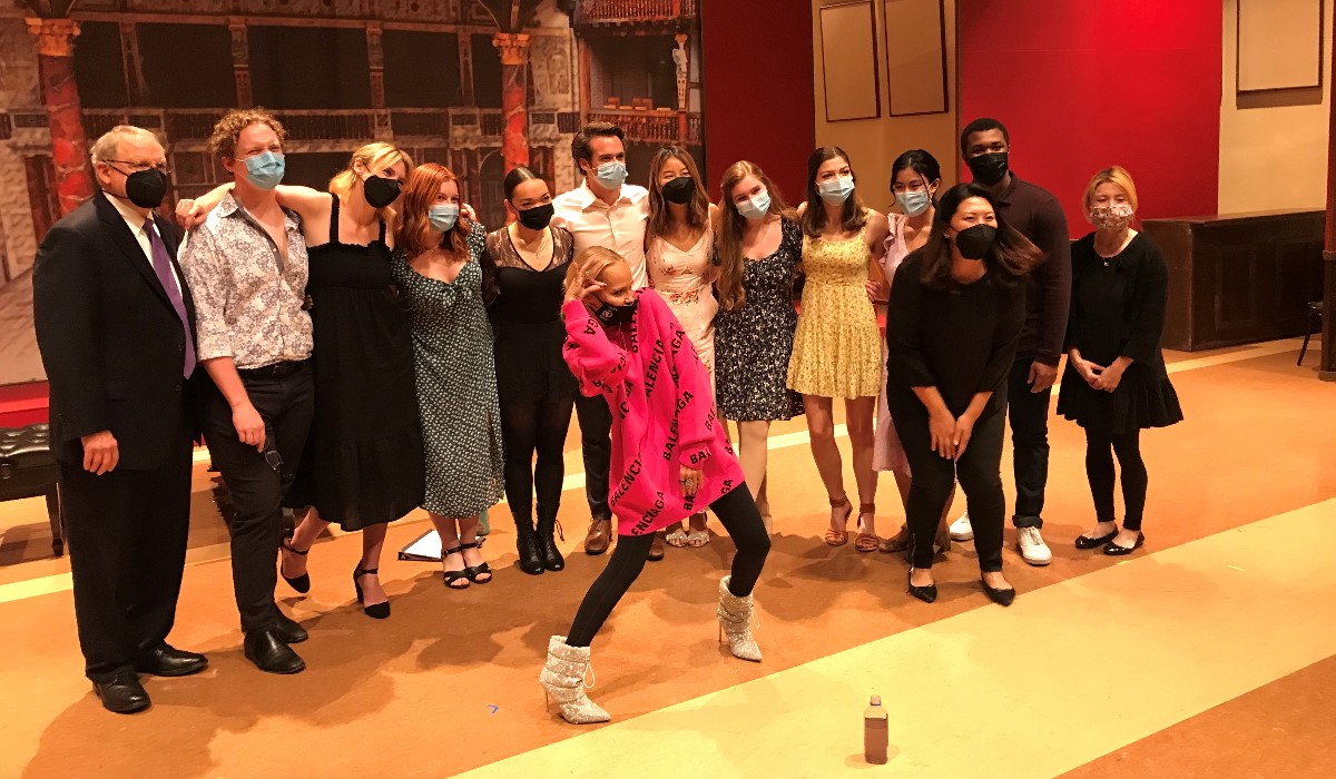 Actor Kristin Chenoweth on stage posing with Chapman students