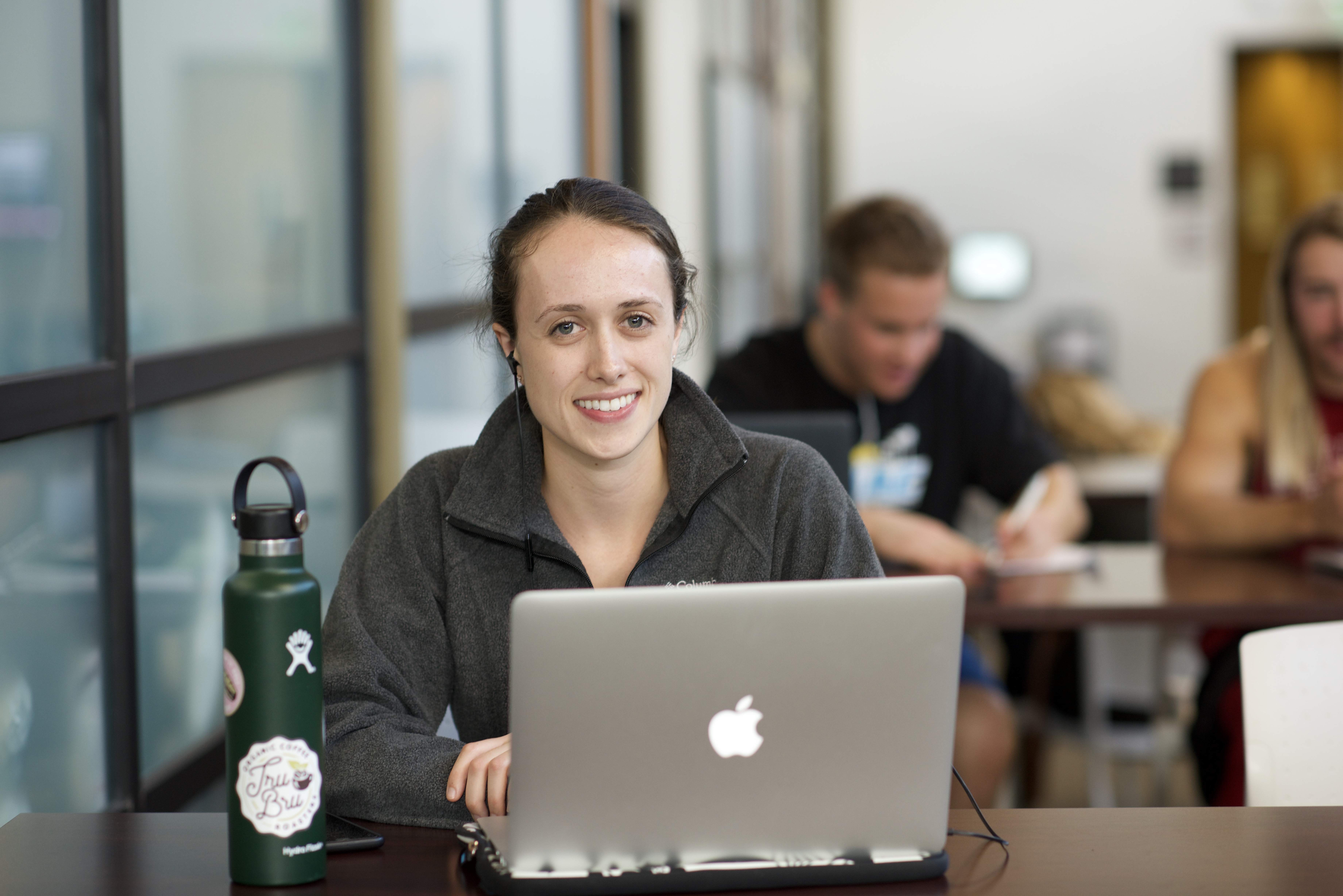 woman sitting with a laptop at a table