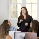 woman teacher in class with small group of students