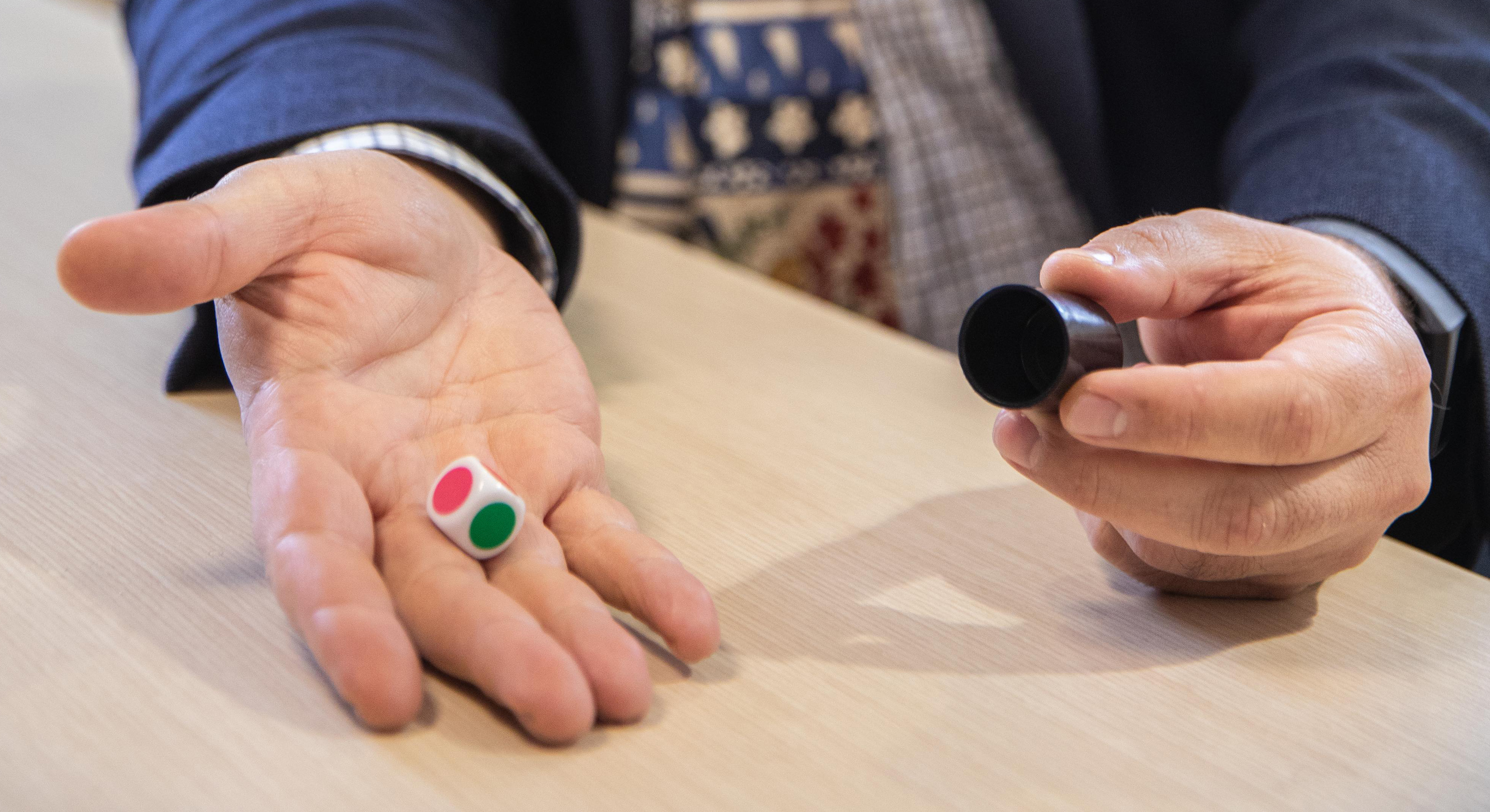 Professor Amir Raz holds a colored die as part of an experiement. 