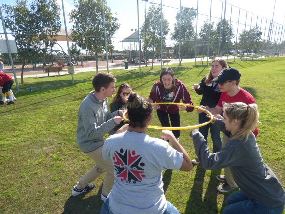 students on field with a hula hoop