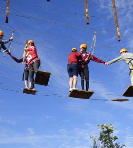 students on platforms in a ropes course