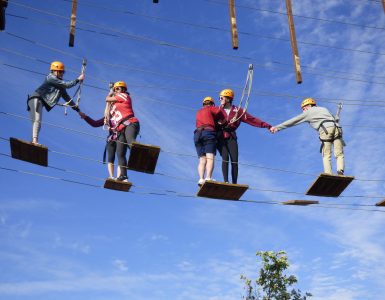 students on platforms in a ropes course