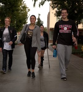group of friends at college walking on campus
