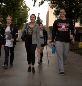 group of friends at college walking on campus