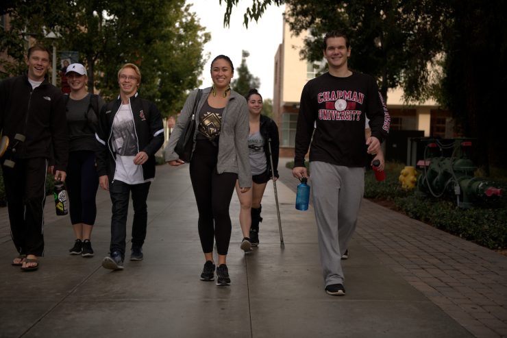 group of friends at college walking on campus