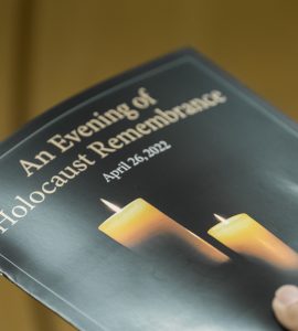 Image of the event program, which reads: An Evening of Holocaust Remembrance" and features a lit candle.