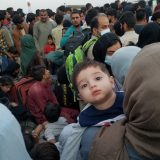 young boy in mother's arm in a crowd