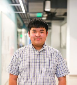 Kevin Nguyen poses in the Keck Center hallway.