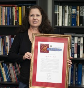 Lori Cox Han with a state resolution