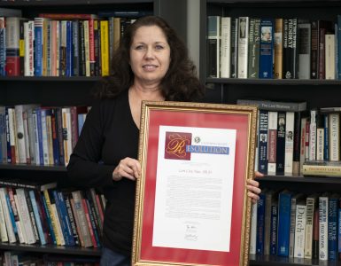 Lori Cox Han with a state resolution