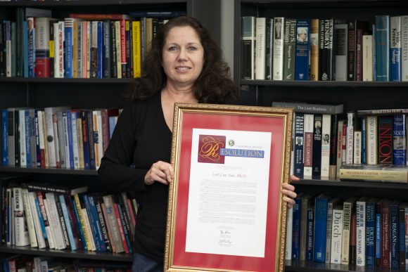 Lori Cox Han with a state resolution