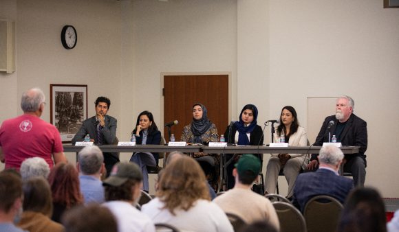 panel of afghan scholars in front of a classroom