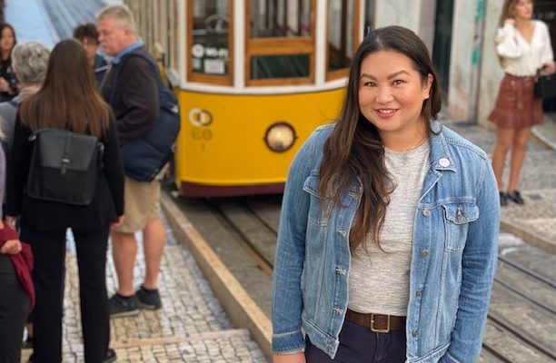 emily nguyen in front of san francisco stree car