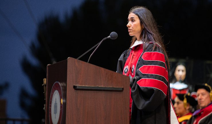 nadia murad in academic robe behind podium