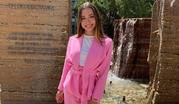 Arianna Benitez poses in front of the fountain in the Piazza at Chapman