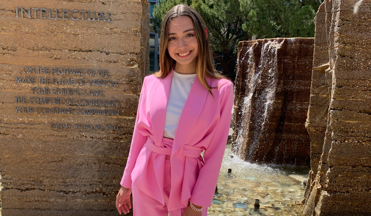 Arianna Benitez poses in front of the fountain in the Piazza at Chapman