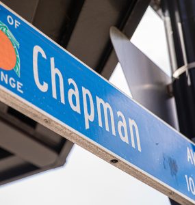 blue street sign from the City Orange with the street name Chapman Ave