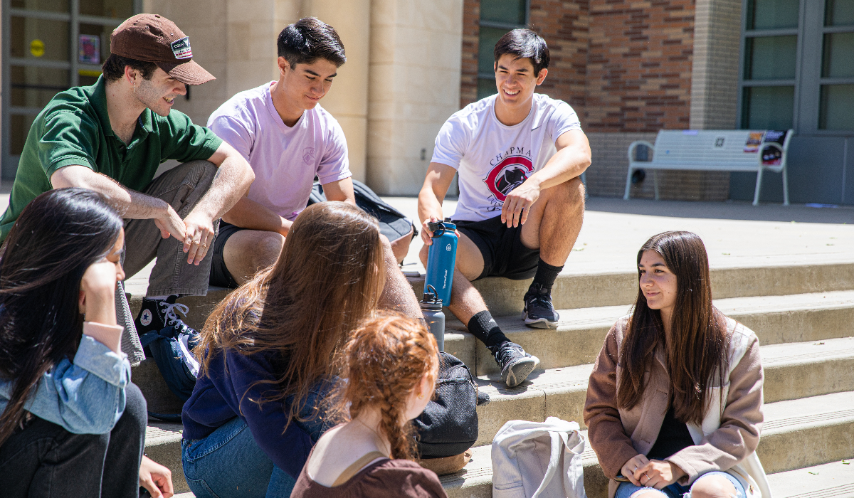 group of university students sitting on steps