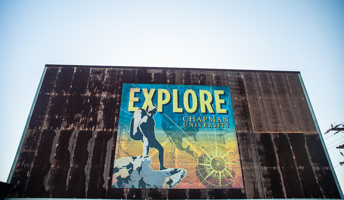 old building faced with large poster that reads EXPLORE CHAPMAN UNIVERSITY
