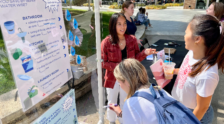 Kainani Tacazon '24 talks with other students.