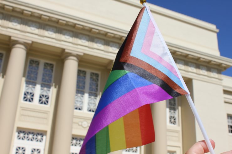 LGBTQIA+ flag in front of Chapman campus building
