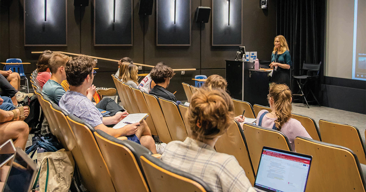 kelli fuery in front of lecture hall class
