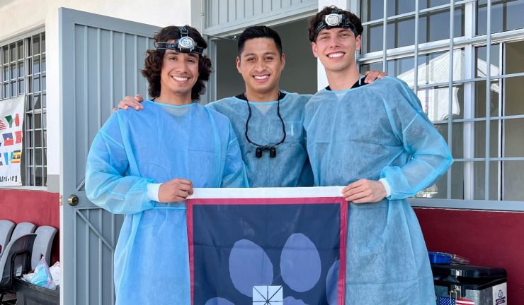 randy rosales with two pre-dental students in scrubs