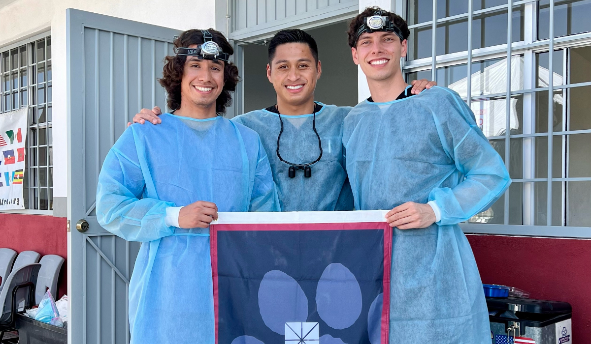 randy rosales with two pre-dental students in scrubs