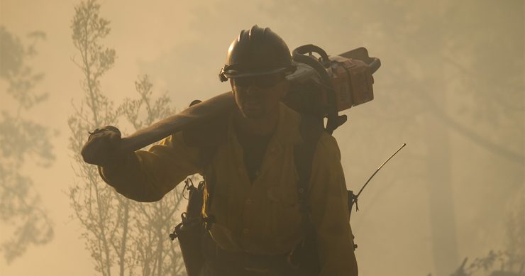 firefighter silhouetted against smokey backdrop