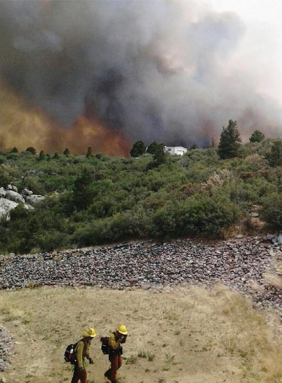 firefighters on burning hillside