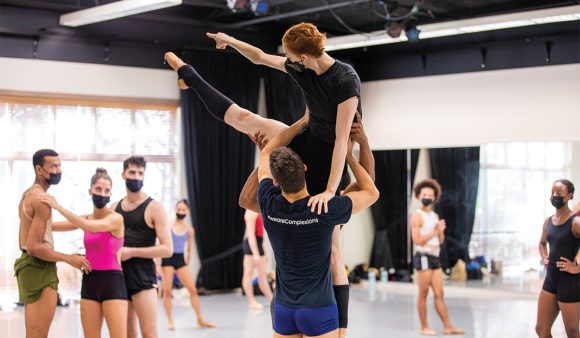 dancers practice a lift in the rehearsal studio