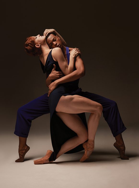 two dancers embrace artistically