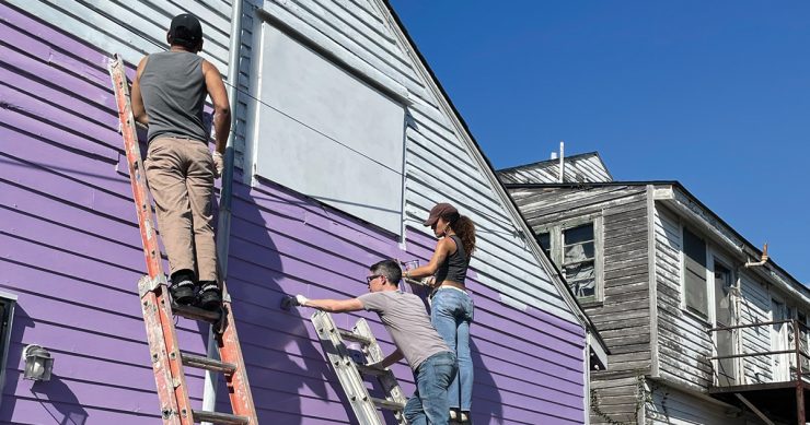 students painting side of house purple