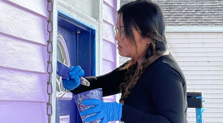 Student works on a door in New Oreans during Interterm course. 