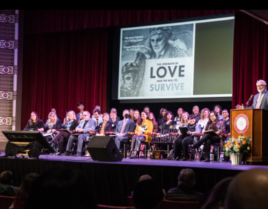 people seated on stage for the March 10, 2023 Holocaust Art & Writing Contest awards ceremony at Chapman University