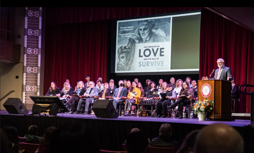 people seated on stage for the March 10, 2023 Holocaust Art & Writing Contest awards ceremony at Chapman University
