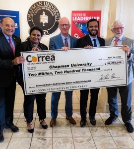 Five individuals from Chapman University and Congressman Lou Correa's office pose with a $2.2 million check.
