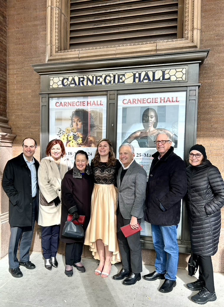 Madison Weiss poses with Chapman Family members at Carnegie Hall.