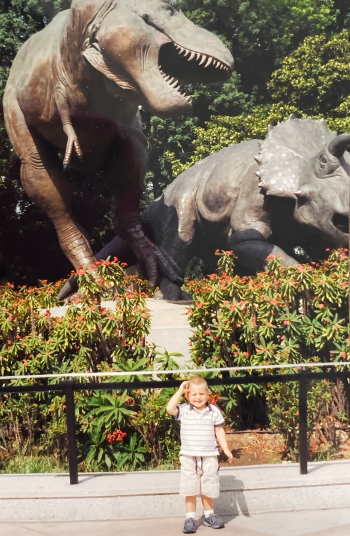 baby-ben-rotenberg-posing-with-dinosaur-statues