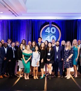 group of honorees by 40 Under 40 sign