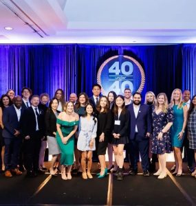 group of honorees by 40 Under 40 sign