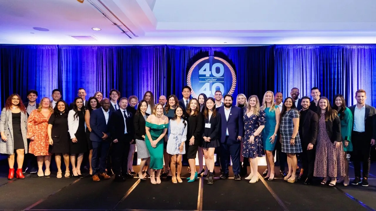 group of honorees by 40 Under 40 sign