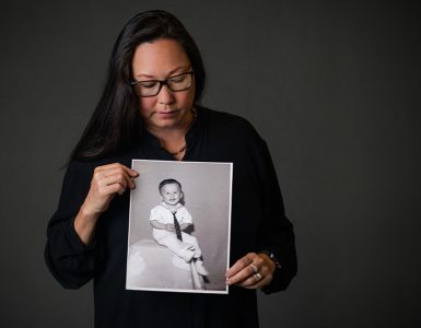 stephanie takaragawa holding black and white portrait of young boy